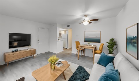 a living room with a couch and a coffee table and a tv